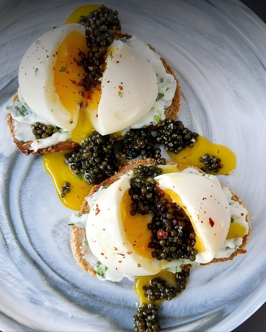 Burrata cheese appetizer topped with Royal Osietra Caviar and tomato jam on toasted herbed focaccia