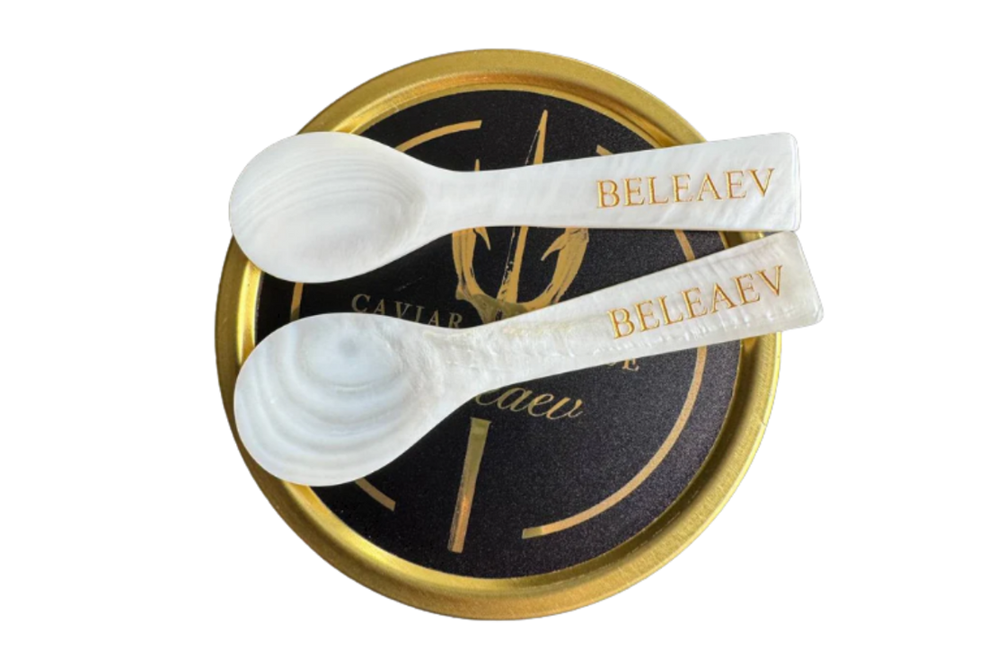 Close-up of elegant mother of pearl caviar spoons showcasing their iridescent, smooth surface ideal for preserving caviar flavor.