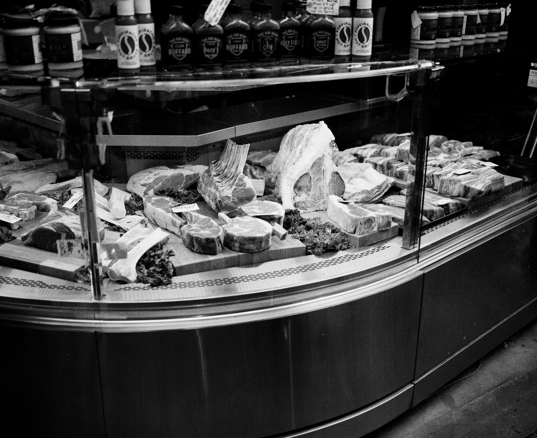 Butcher counter with different beef cuts in London; editorial image for the UK buying guide