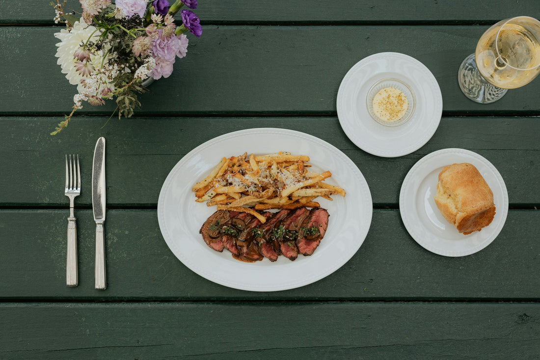 Cooked steak with potatoes and wine; editorial image for the A4 cooking guide