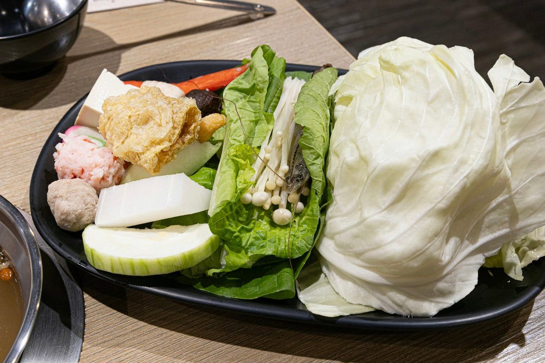 Fresh vegetables and tofu arranged as ingredients for a hot-pot meal