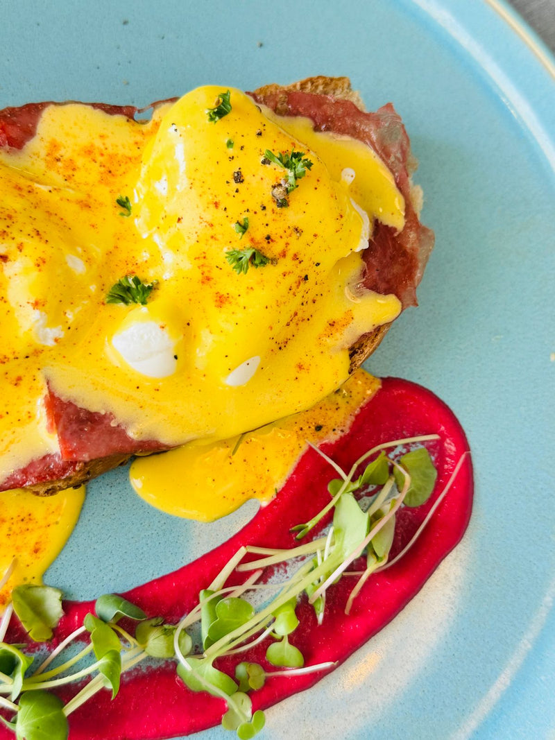 Eggs Benedict with rich hollandaise and microgreens