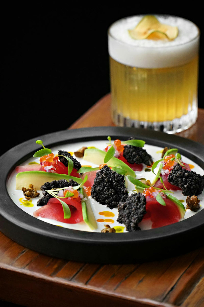Elegant corporate caviar gift set with mother-of-pearl spoon on dark background