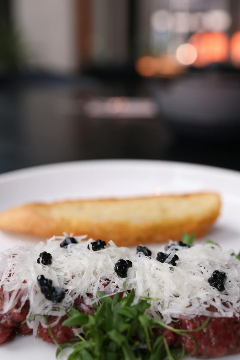 Red and black caviar side by side showing color contrast between salmon roe and sturgeon caviar