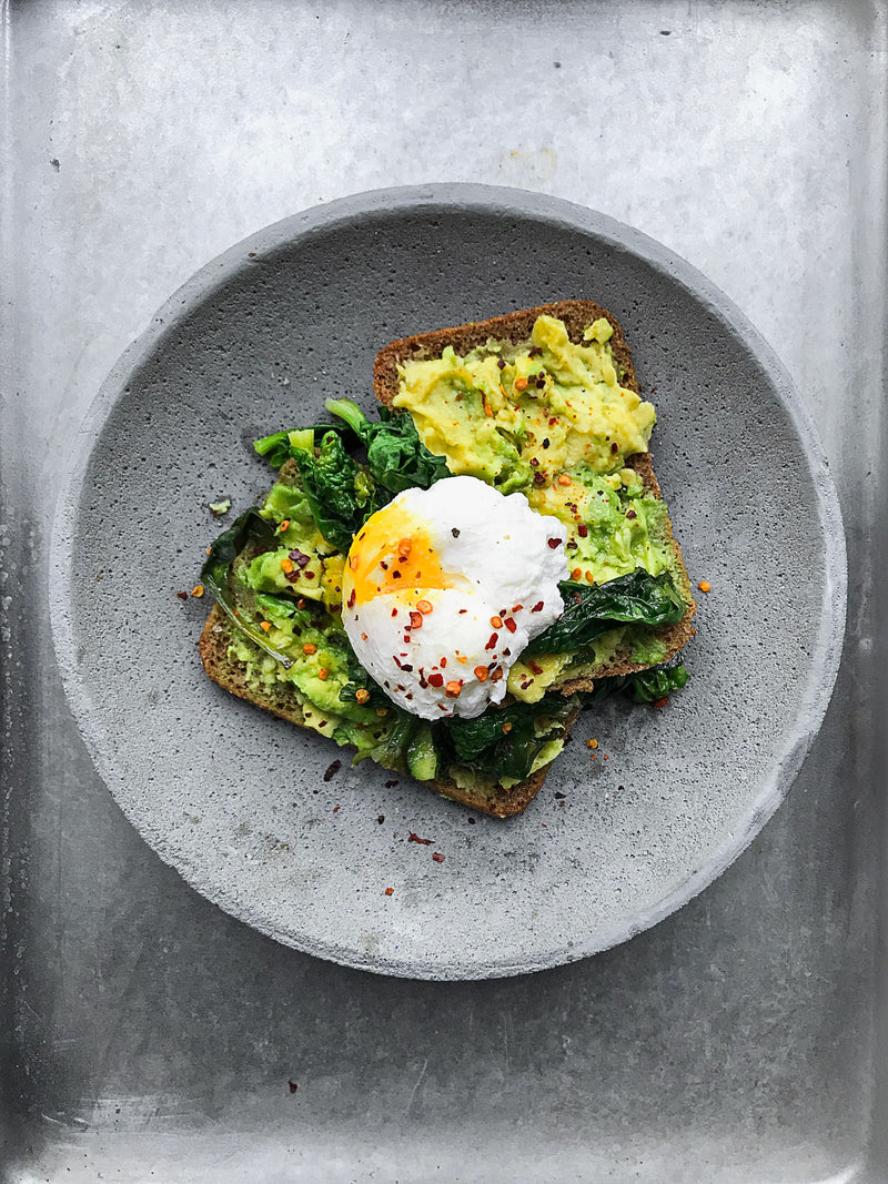 Soft-boiled egg in cup with truffle butter brioche soldiers