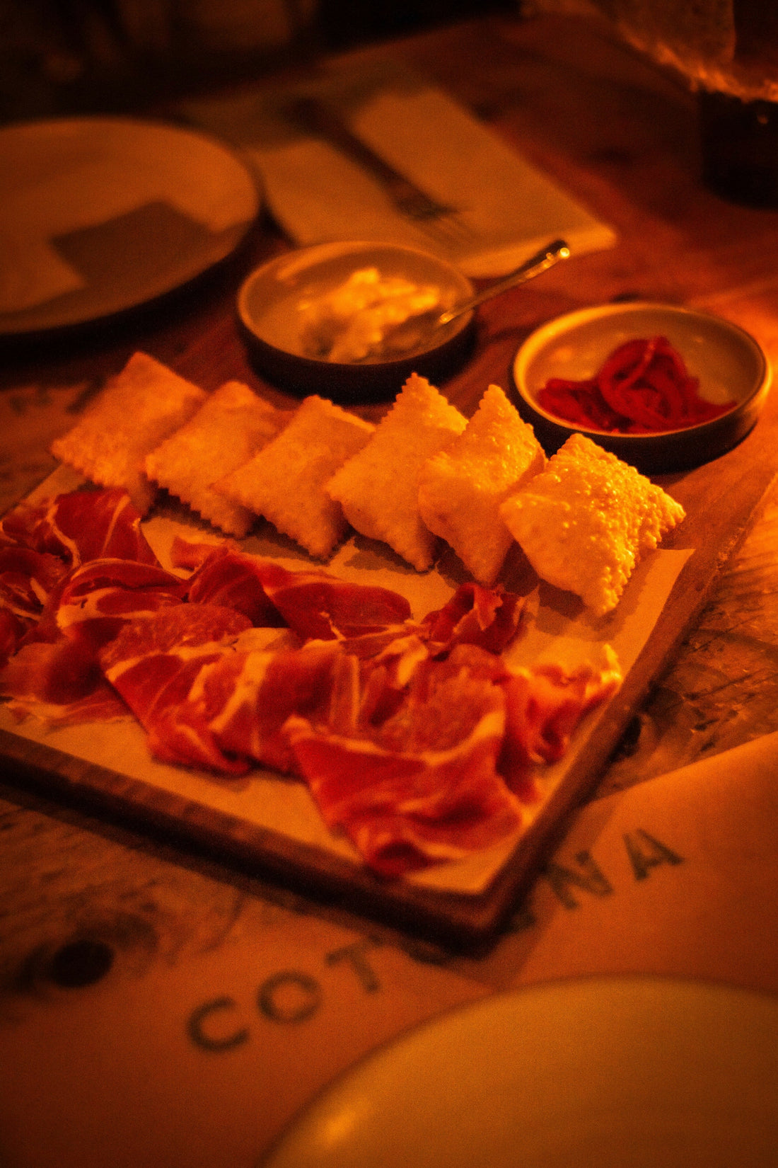 Charcuterie board with cured meat and pastries; editorial image for canapé serving