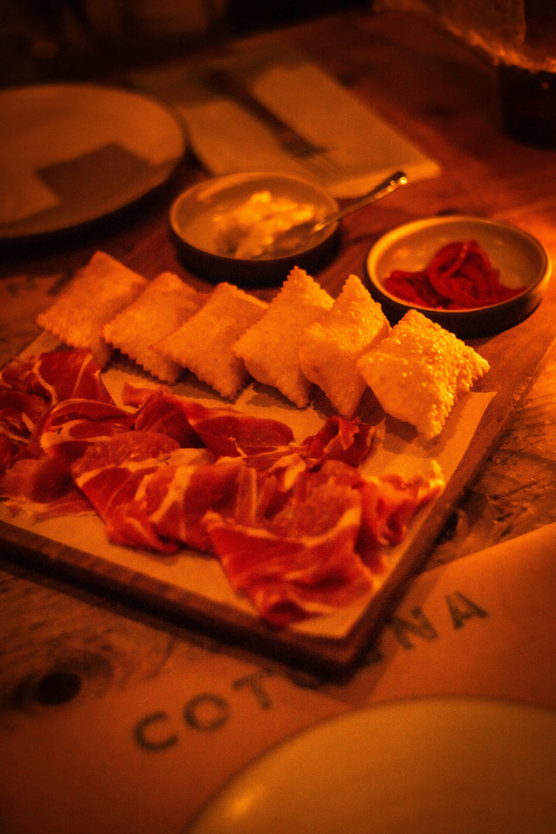 Charcuterie board with cured meat and pastries; editorial image for canapé serving