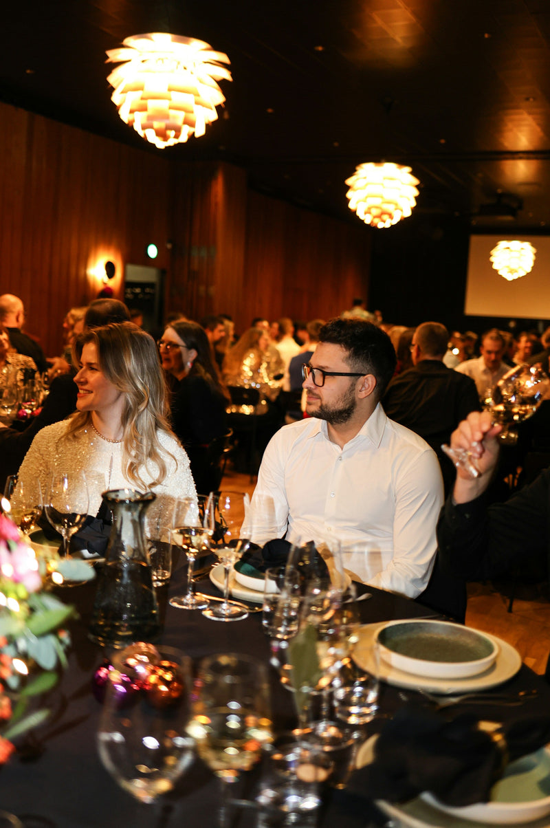Guests seated at an elegant dinner party