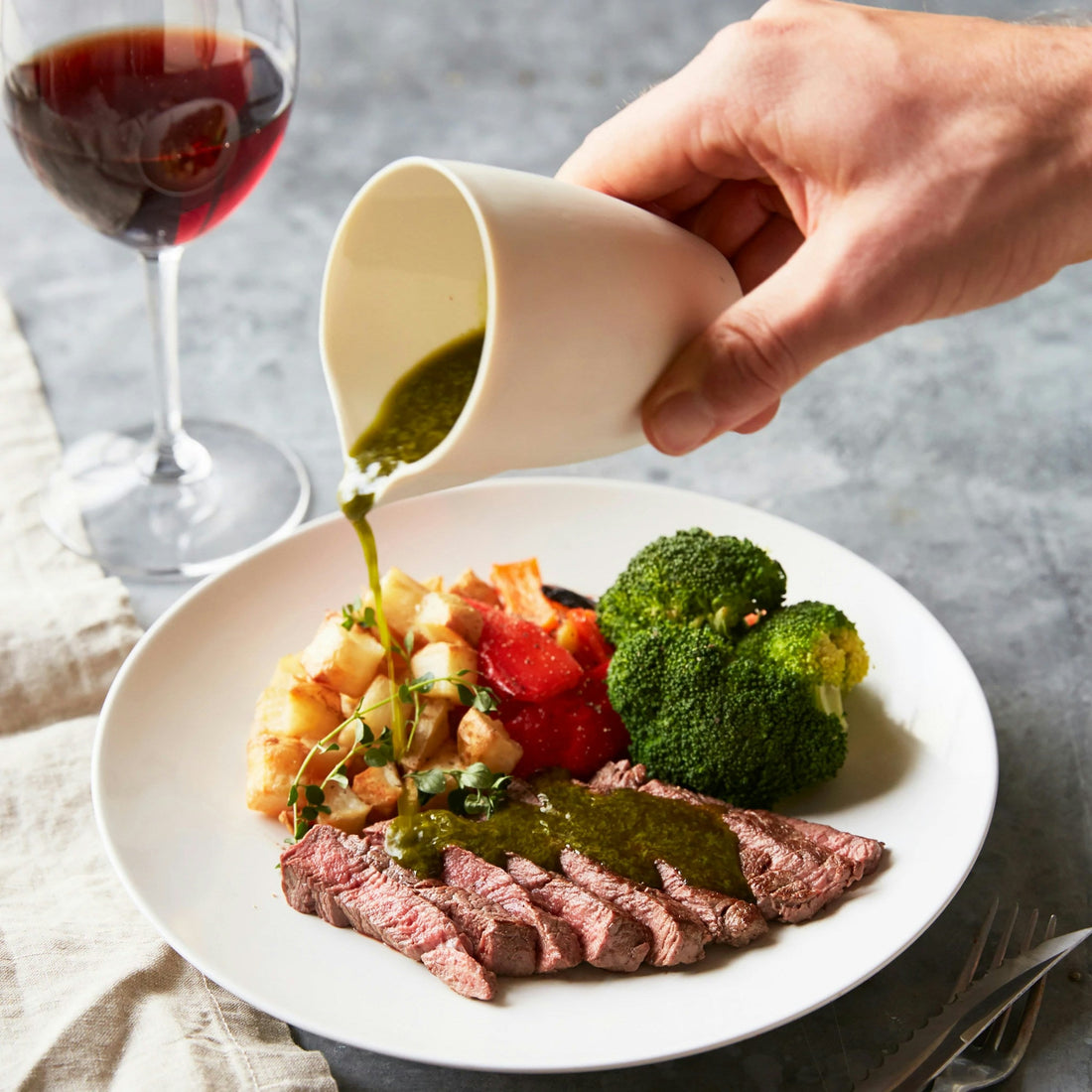 Steak served with vegetables and red wine; editorial image for the mushroom salad recipe