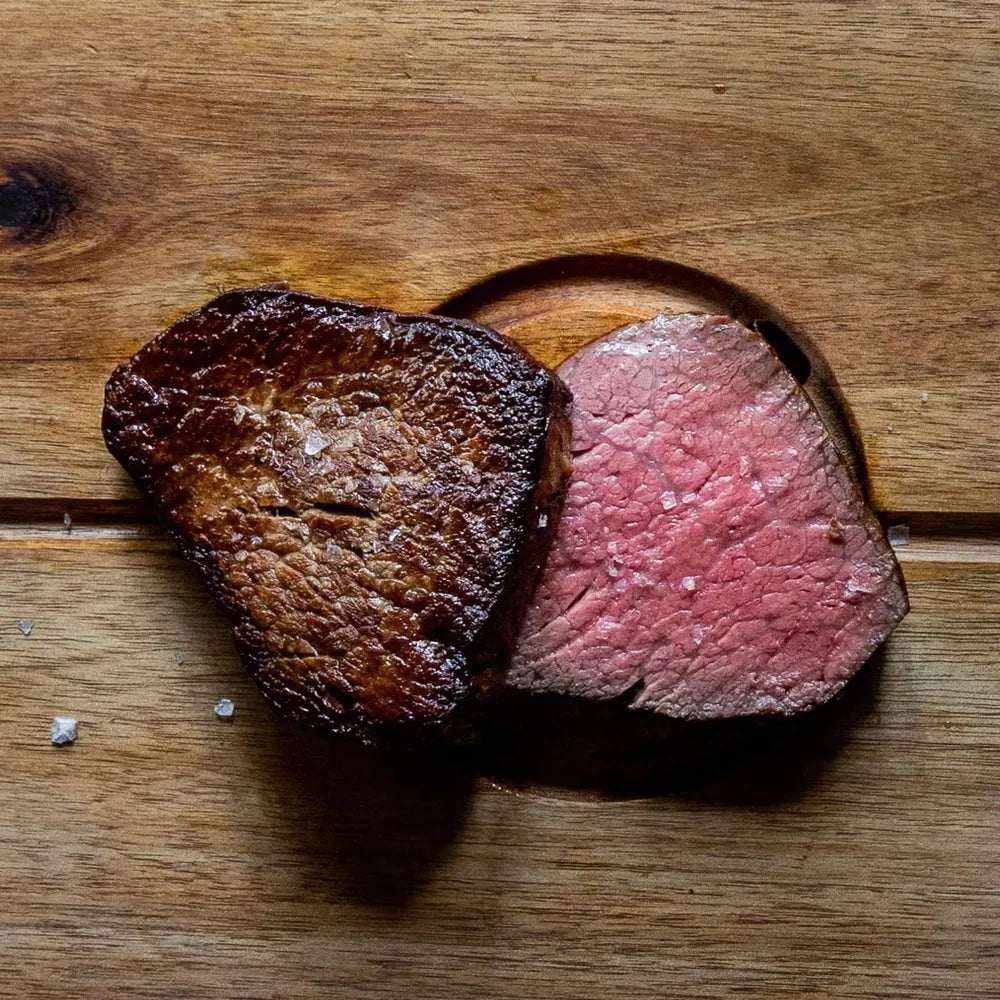 Meat & Poultry beef steak with a browned seared crust and tender pink centre, sliced to show its texture