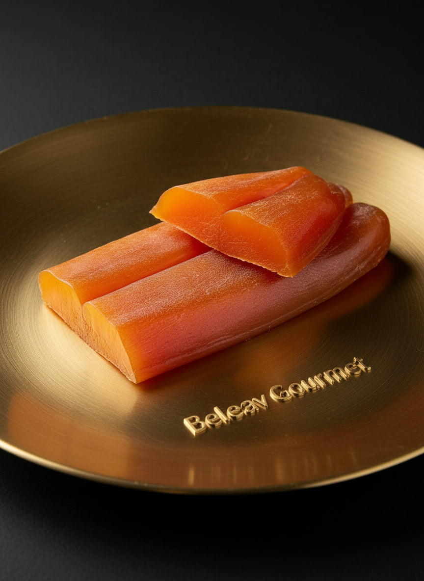Three pieces of raw salmon on a white marble surface