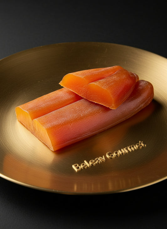Three pieces of raw salmon on a white marble surface