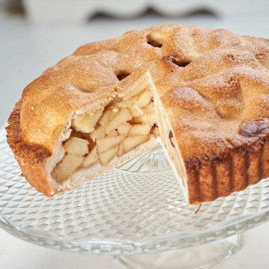 American apple pie slice with Bramley apples and cinnamon filling on white plate