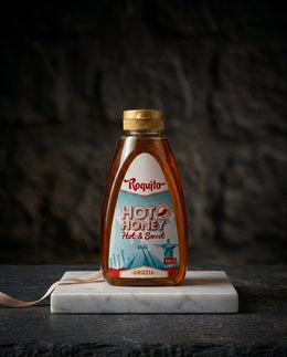 Jar of Hot Honey Roquito 720g with vibrant label on wooden surface