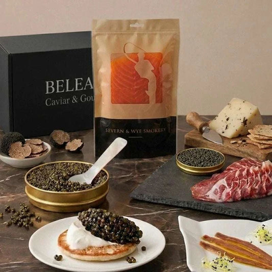 Grand Caviar Board featuring Beluga Reserve and Oscietra Royal caviar with smoked salmon, aged cheese, cured meat, pickled walnuts, blinis, and toast.
