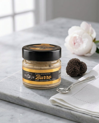 Black Truffle Butter 70gr packaged in a jar with a spoon and fresh truffle slices.