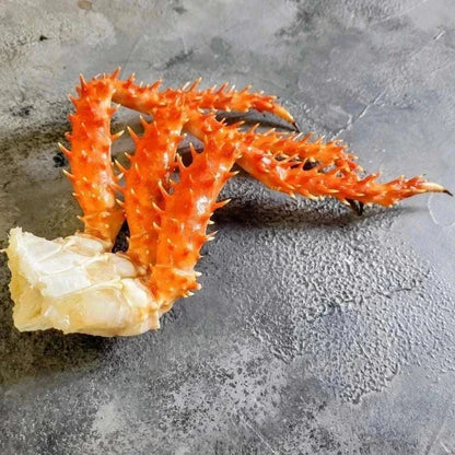 Cooked frozen Chilean king crab clusters with bright red spiked shells