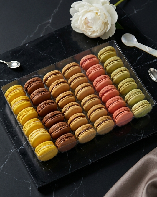 Assortment of six classic frozen French macarons in various flavors arranged as a patisserie centerpiece