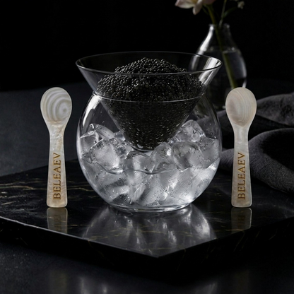 Beleaev Glass Caviar Chiller Set with hand-blown glass bowl and mother-of-pearl spoons on crushed ice base