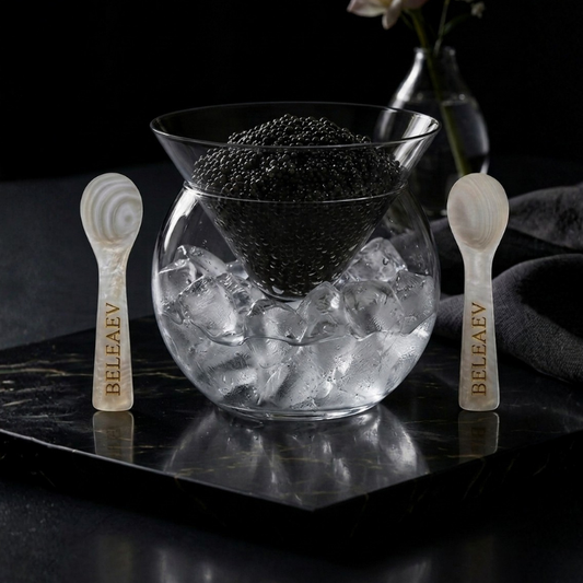 Beleaev Glass Caviar Chiller Set with hand-blown glass bowl and mother-of-pearl spoons on crushed ice base