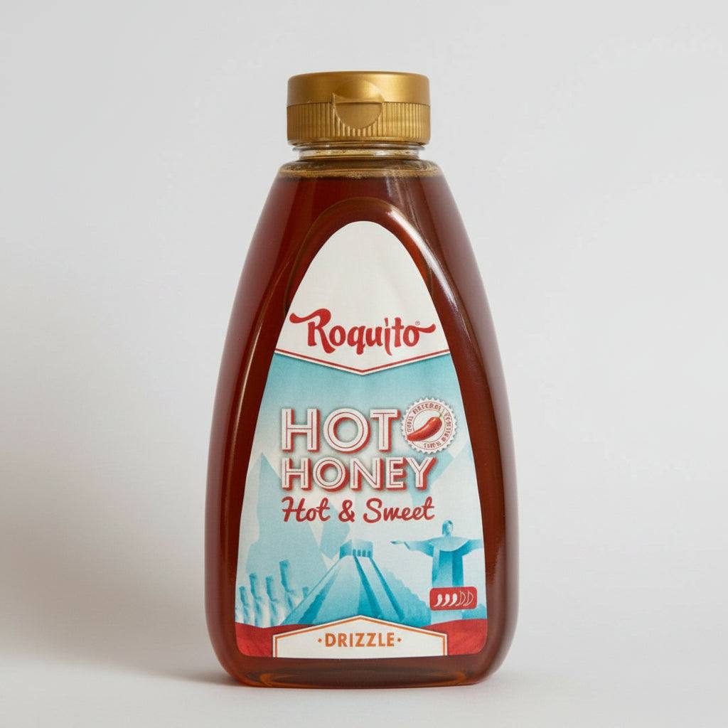 Glass jar of Hot Honey Roquito 720g with honey dipper and red chili peppers