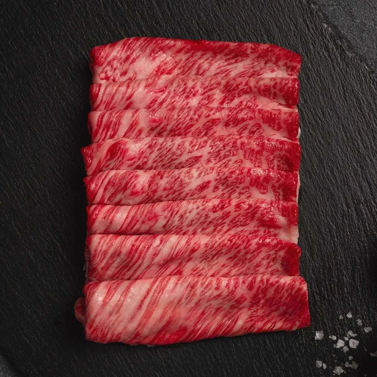 Thinly sliced Japanese A5 Wagyu Chuck Roll with fine marbling