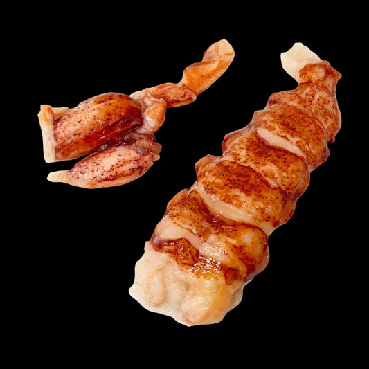 Two pieces of cooked meat, likely chicken or pork, on a white background