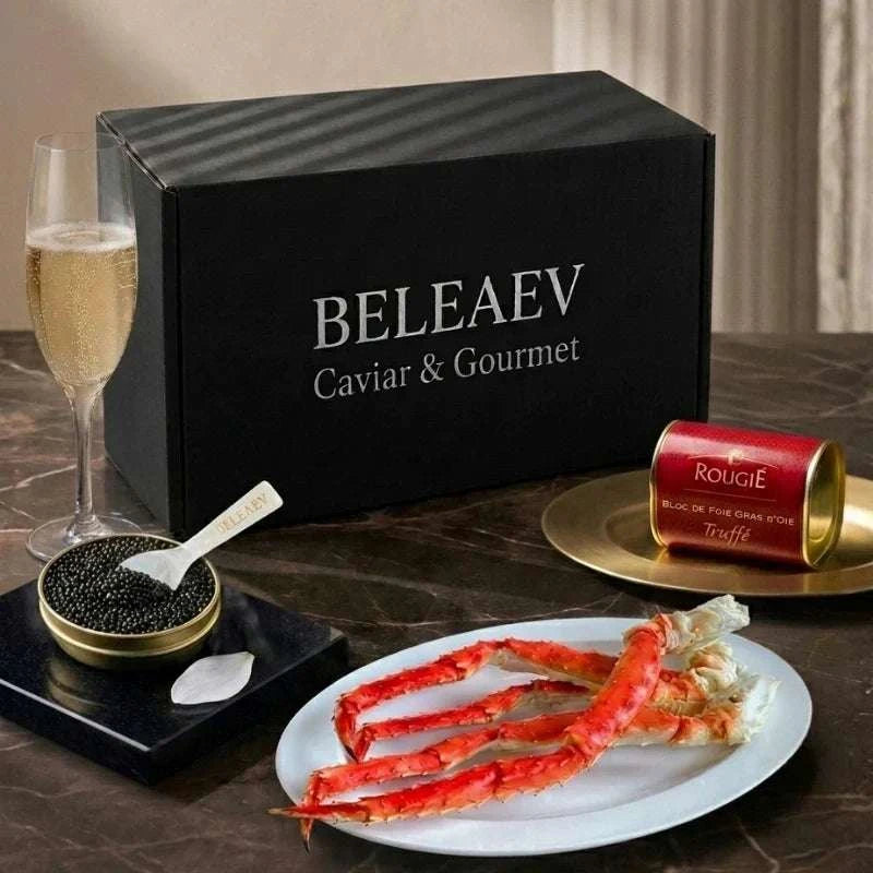 Luxury caviar hamper with Oscietra Royal caviar, Chilean king crab clusters, Rougié foie gras with truffles, blinis, and mother-of-pearl spoon
