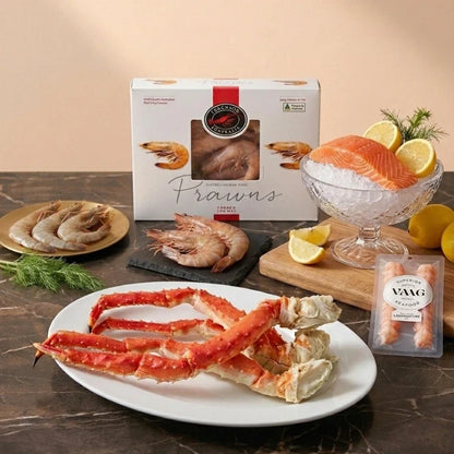 Luxury seafood box with king crab, langoustine tails, prawns, and smoked salmon