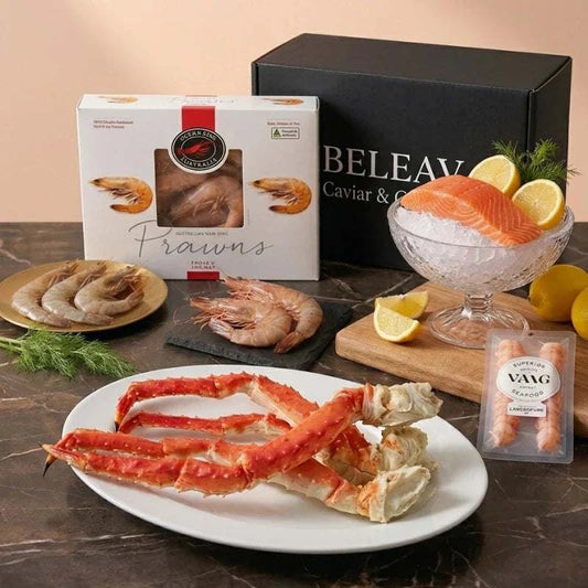 Luxury seafood box featuring Chilean king crab, langoustine tails, Spencer Gulf prawns, and smoked salmon on ice