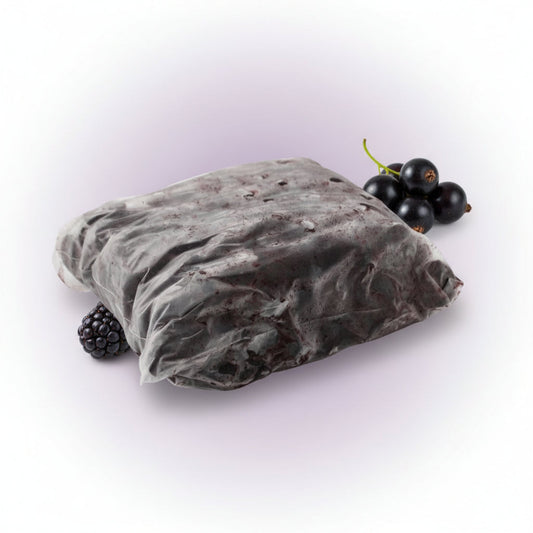 Purée Acai with Guarana in a dark purple frozen block inside a clear plastic pouch, with acai berries beside it