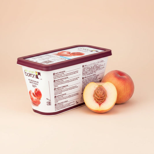 Purée White Peach in a white rectangular tub with a burgundy lid, shown with whole and halved peaches.
