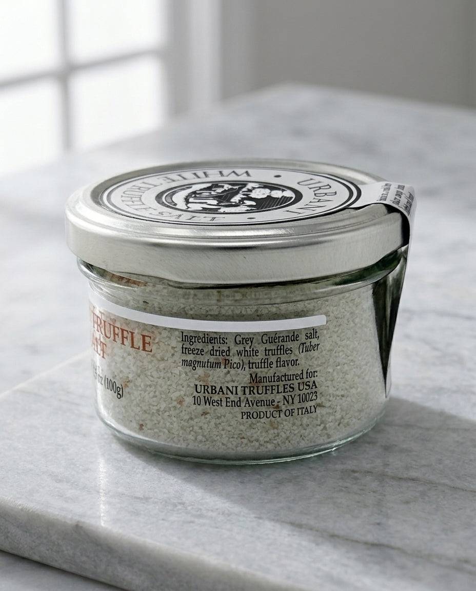 Jar of White Truffle Salt 100gr with wooden spoon on dark background