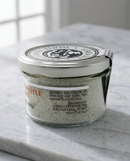 Jar of White Truffle Salt 100gr with wooden spoon on dark background